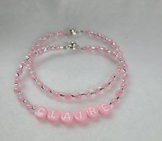 Listing is for ONE bracelet, your choice of name bracelet or plain. Order 1 of each to stack.  Sweet pink personalized bracelet.  Handmade to order using 4 mm alpha plastic bead,  pink and clear silver lined 6/0 size seed glass beads and wire strung with button clasp.  Clasp is easy use, just press top button to open and close.    Please double check name spelling and wrist size using a measuring tape, add 1/2 inch for snug fit, add 1 inch for loose fit.  Nicely packaged, Bracelet will be placed Tooth Fairy Pillows, Bracelet Name, Friendship Bracelets With Beads, Gift Bracelet, Tooth Fairy Pillow, Bracelet Friendship, Personalized Bracelet, Bracelet Diy, Silver Line