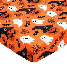 an orange sheet with black and white ghost faces on it