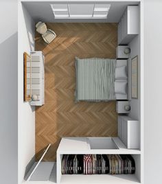 an overhead view of a small bedroom with bed, desk and closet space in it