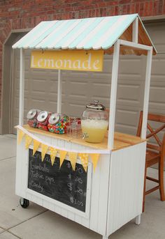 a lemonade stand is set up outside on the sidewalk