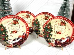 three plates with christmas designs on them sitting next to a tree