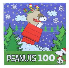 the peanuts book is on display in front of snowflakes and christmas trees, with an image of a dog flying through the air