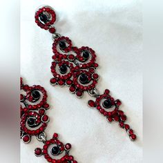 Red And Black Rhinestone Dangly Earrings. The Gemstones Remind Me Of Swarovski Crystals, Absolutely Gorgeous. Swirly And Spiral Like Patterned Shape. These Are Sure To Glam Up Any Look For A Special Occasion. Never Worn. Tags For Exposure: #Redandblack #Sparklyearrings #Rhinestoneearrings #Fancyearrings #Alternative Paisley Shape Gemstone Earrings Statement Piece Earrings Red And Black Alternative Goth Style Dark Style Vampy Style Vampire Costume Earrings Elegant Wedding Earrings Red Crystal Metal Earrings For Parties, Red Crystal Metal Party Earrings, Red Metal Crystal Party Earrings, Red Jeweled Metal Earrings, Red Jeweled Earrings For Evening, Red Glamorous Chandelier Earrings For Party, Red Glamorous Chandelier Earrings For Evening, Glamorous Red Chandelier Earrings For Party, Glamorous Red Chandelier Earrings For Evening