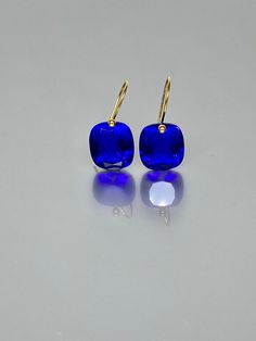 Beautiful faceted ink blue color sapphire drop earrings. The faceted rectangel drops are attached to 14K/18K  SOLID GOLD ear wires.  The earrings are elegant and have a lux look. A truly gorgeous pair of earrings. ** SOLID GOLD EAR WIRES:  The ear wire ends are stamped as proof of being 14K solid gold. In addition, extra work was done at the end of the ear wires to prevent any sort of pain or injury while inserting them through the ear lobes. **The 14K WHITE solid gold ear wires are RHODIUM plated to prevent tarnish of the ear wires over time. * Quality: Superb  AAA+ Flawless Ink Blue Sapphire * Carat (26 ct.) *  Stone Shape: Rectangle * Stone Cut : Emerald cut * The dimension of stones: 16x14 mm/ 0.6x0.5 Inches *Metal:  14K SOLID GOLD * Type of Gemstone: lab created * Earrings drop length Blue Briolette Earrings For Formal Occasions, Modern Sapphire Earrings For Formal Occasions, Blue Rectangular Faceted Jewelry, Modern Sapphire Gemstone Earrings, Modern Blue Jewelry With Rectangular Stone, Modern Blue Faceted Jewelry, Elegant Blue Cushion Cut Earrings, Blue Rectangular Gemstone Earrings, Extra Work