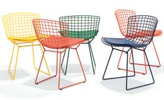 four different colored chairs sitting next to each other