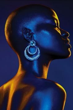 an image of a woman with blue skin and earrings