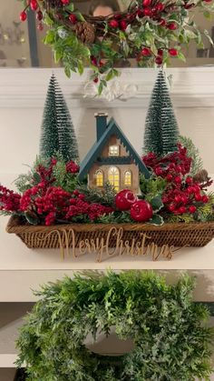 two christmas wreaths on top of each other with trees and houses in the background