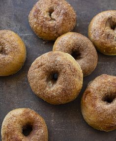 several sugared donuts on a baking sheet