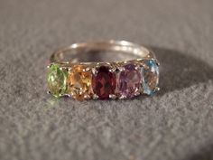 I am offering you this spectacular sterling silver vintage ring. This piece is distinctive and beautiful with stunning styling. * sterling silver multi-gem ring * genuine amethyst, peridot, garnet, citrine and blue topaz oval individually set stones * classic band * size 7 1/2 This ring was discovered in an estate sale here in upstate New York. This item is sold in as-is condition. Buyer pays all shipping and handling. Oval Multi-stone Birthstone Ring For Anniversary, Oval Multi-stone Gemstones For Wedding, Multicolor Oval Gemstones For Anniversary, Oval Multicolor Gemstones For Anniversary, Multicolor Oval Birthstone Ring For Anniversary, Oval Multicolor Birthstone Ring For Anniversary, Vintage Oval Gemstones For Wedding, Elegant Multicolor Oval Topaz Ring, Oval Vintage Gemstones For Wedding