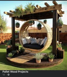 an outdoor seating area with hanging plants and potted plants on the side of it