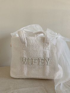 a white bag with the word wipey written on it sitting on a table next to a tulle