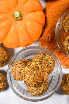 several balls of food sitting on top of a table next to pumpkins and a scarf