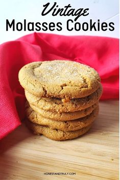 a stack of cookies sitting on top of a wooden table next to a red cloth