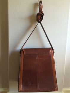 "Beautiful vintage bag in a very heavy durable leather in two shades of cognac brown. Magnetic snap closure. Measures Drop22 1/2\" on first buckle hole (19 1/2\" on last buckle hole) Length11\" Height12 1/2\" Wide6\" Feel free to convo me with any further questions. Thank you for your interest." Leather Cross Body Purse, Cross Body Handbag, Santa Doll, Salty Dog, Providence Ri, Cross Body Purse, Leather Handbags Crossbody, Vintage Bag, Leather Cross