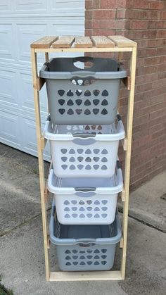 three plastic laundry baskets stacked on top of each other in front of a garage door