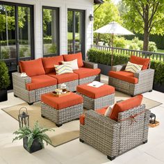 an outdoor living room with wicker furniture and orange cushions