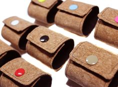 several cork cases with different colored buttons on them