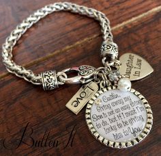 a charm bracelet with a quote on it and charms attached to the clasp that says, i love you