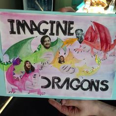 a child holding up a sign that says imagine, dragon's