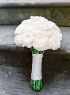 a bouquet of white flowers sitting on the steps