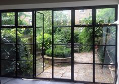 an open glass door leading to a garden