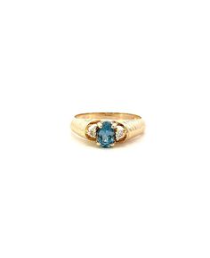 Immerse yourself in the serene elegance of our 14KT Yellow Gold Aquamarine Ring, a masterpiece designed for those who appreciate the finer details in life. This exquisite piece centers around a breathtaking oval Aquamarine, celebrated for its captivating sea-blue hue that evokes the tranquility of ocean waters. Each side of this mesmerizing gemstone is adorned with a sparkling round diamond, adding a touch of timeless grace and enhancing the ring's overall brilliance. Crafted with meticulous attention to detail, this ring is fashioned from premium 14KT yellow gold, known for its warmth and durability. The design seamlessly marries classic charm with modern sophistication, making it a versatile addition to any jewelry collection. With a total weight of 2.10 dwt, this ring strikes the perfec Oval Three Stone Topaz Ring For Formal Occasions, Timeless Oval Topaz Ring With Diamond, Classic Oval Three Stone Topaz Ring, Heirloom Oval Topaz Ring With Diamond Accents, Elegant Oval Topaz Three Stone Ring, Formal Oval Three-stone Topaz Ring, Oval Three-stone Topaz Ring, Yellow Gold Aquamarine Jewelry With Center Stone, Yellow Gold Aquamarine Jewelry With Accent Stones