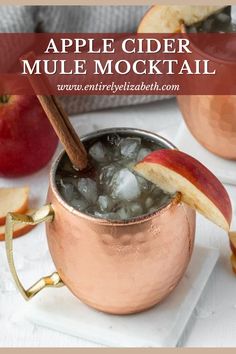 Mule Mocktail in a copper mug surrounded by ice and apples. Mocktails Non Alcoholic Apple Cider, Hot Apple Cider Mocktail Non Alcoholic, Mocktail Apple Cider, Apple Cider Mule Mocktail, Sparkling Apple Cider Mocktail Non Alcoholic, Non Alcoholic Cider Drinks, Sparkling Apple Cider Non Alcoholic, Mocktail Fall Drinks, Non Alcoholic Apple Cider Drinks