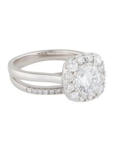 a white gold ring with an oval cut diamond in the center