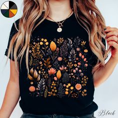 Autumn Wildflower Forest Unisex Tee Shirt | Botanical Wildflower Tee | Autumn T-shirt | Nature Lover Shirt ✔️ Soft, light and comfortable unisex short sleeve tee ✔️ 100% Airlume combed and ringspun cotton (fiber content may vary for different colours*) ✔️ Light fabric (4.2 oz/yd² (142 g/m ✔️ Retail fit 📏 Runs true to size ✔️ Dual side seams for structural support of the garment help hold its shape longer ✔️ Ribbed knit elastic collars to bolster shaping, twill taped shoulders to prevent stretch Trendy Crew Neck Tops With Plants Print, Bohemian Short Sleeve Top With Plant Print, Multicolor Crew Neck Shirt With Plant Print, Black Tops With Plant Print For Spring, Casual Fall Tops With Plant Print, Bohemian Tops With Plant Print And Crew Neck, Short Sleeve Floral Print Tops For Fall, Black Botanical Top For Spring, Fall Short Sleeve Shirt With Plants Print