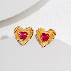 hese earrings feature a vintage-inspired design with a heart-shaped motif. They are made of pure silver and are plated with gold, giving them a luxurious and timeless look. The earrings are lightweight and comfortable to wear, making them suitable for everyday wear or special occasions. The heart-shaped design adds a touch of romance and femininity to any outfit, making them a great gift option for a loved one or a beautiful addition to your own jewelry collection. Remove your earrings when performing certain activities: Avoid wearing your 925 sterling silver earrings when exercising, swimming, showering, or sleeping. These activities can expose your earrings to moisture and chemicals that can cause tarnishing and discoloration. Clean your earrings regularly: To prevent tarnishing, clean y Unique Studs, Pink Heart Earrings, Sterling Silver Jewelry Earrings, Heart Earring, September Birthstone Jewelry, Zircon Earrings, Zodiac Gifts, Heart Shaped Earrings, Pearl Jewellery Earrings