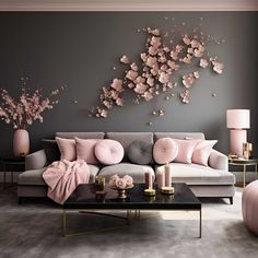 a living room decorated in pink and grey with flowers on the wall above the couch