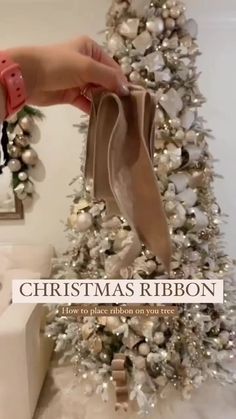 a person holding a bag near a christmas tree with ornaments on it and the words christmas ribbon how to place ribbon on a tree