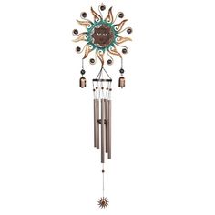 a wind chime that is hanging from the side of a wall with sun and moon designs on it