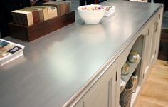 a kitchen counter with bowls and boxes on it