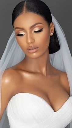 a woman wearing a wedding veil and makeup