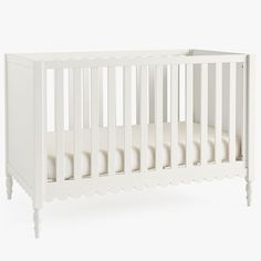 a white crib with no mattress in it