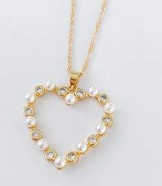 "Pearl heart necklace MATERIAL AND SIZE 18k Gold plated Heart Pearls and cubic zirconia Heart size: 2.5cm Chain length: 45cm or 18\" If you have questions about the product, feel free to reach me out. Don't forget to check out my other items in the store: Https://www.etsy.com/shop/nyahwithlove" Valentine's Day Party Jewelry With Pearl Charm, Heart-shaped Pearl Charm Jewelry For Party, Heart-shaped Pearl Necklace For Party, Valentine's Day Party Pearl Chain Necklaces, Valentine's Day Party Necklace With Pearl Chain, Heart Pendant Pearl Chain For Party, Heart Pendant Pearl Chain Jewelry For Party, Heart Necklace With Pearl Chain For Gift, Party Pearl Chain Jewelry With Heart Pendant