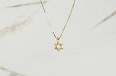 Tiny 14k solid gold star of david necklace. Judaica Jewelry. david star necklace. magen david necklace. kabala necklace. Jewish jewelry This supper tiny Magen David (star of David) is perfect for women or a women who want dainty and tiny pendant. Necklace info : 14kt real solid gold . it can be in yellow or white gold ( select it on the checkout page). The charm wide is 6.6mm High: 10.5 (include hoop) Pendant thickness: 0.67mm. The necklace packaged and shipped in a beautiful gift box. It takes Star Of David Tarnish Resistant Necklace Gift, Minimalist 14k Gold Star Of David Necklace, Minimalist Gold Necklace With Star Of David, Star Of David Necklace For Gift, Gold Minimalist Star Of David Charm Necklace, Elegant 14k Gold Star Of David Jewelry, Silver Star Of David Jewelry In 14k Gold, 14k Gold Star Of David Jewelry Gift, Minimalist Star Of David Sterling Silver Jewelry