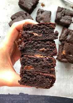 a person holding some brownies in their hand