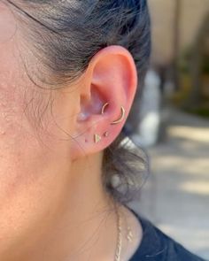 a close up of a person with ear piercings