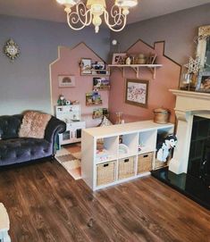 a living room filled with furniture and a fire place under a light chandelier