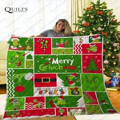 a woman holding up a christmas quilt with the words merry grin on it and an image of