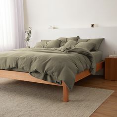 the bed is made up and ready for someone to use it in their home or office