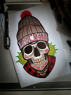 an image of a skull wearing a knitted hat on top of a piece of paper