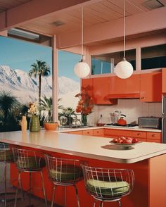 a kitchen with orange cabinets and bar stools in front of an open window overlooking the mountains