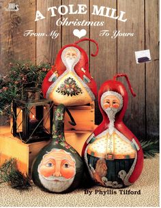 a book cover with santa and mrs claus on top of two vases in front of a wooden fence