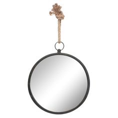 a round mirror hanging on a rope with a knot around the edge and an object attached to it