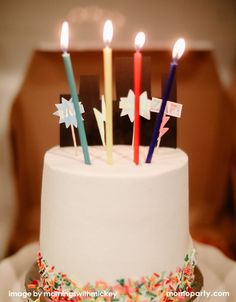 a white cake topped with lots of candles