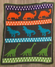 a crocheted afghan with dinosaurs on it