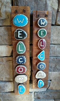 two wooden signs that say welcome and some are made out of wood with letters on them